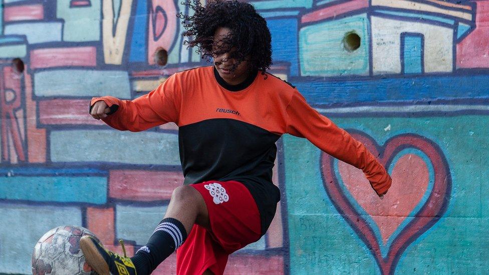 Mayara practises weaving her foot around the ball on the training field