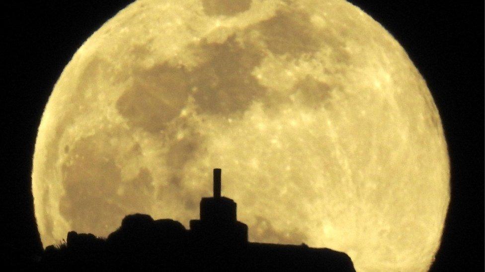 A view of the full moon over Mount Pico Sacro in Spain