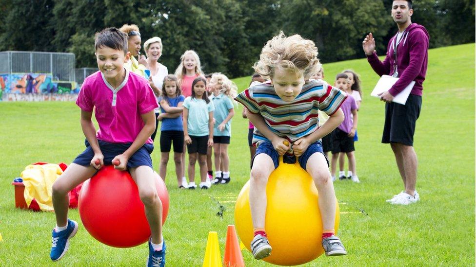 kids race on space hoppers