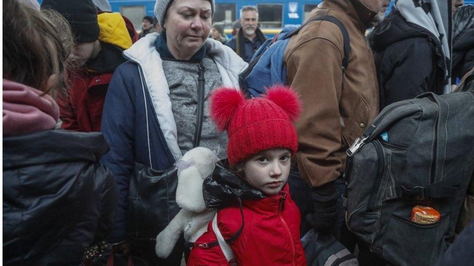 People wait to board a train at Kyiv Main Railway Station