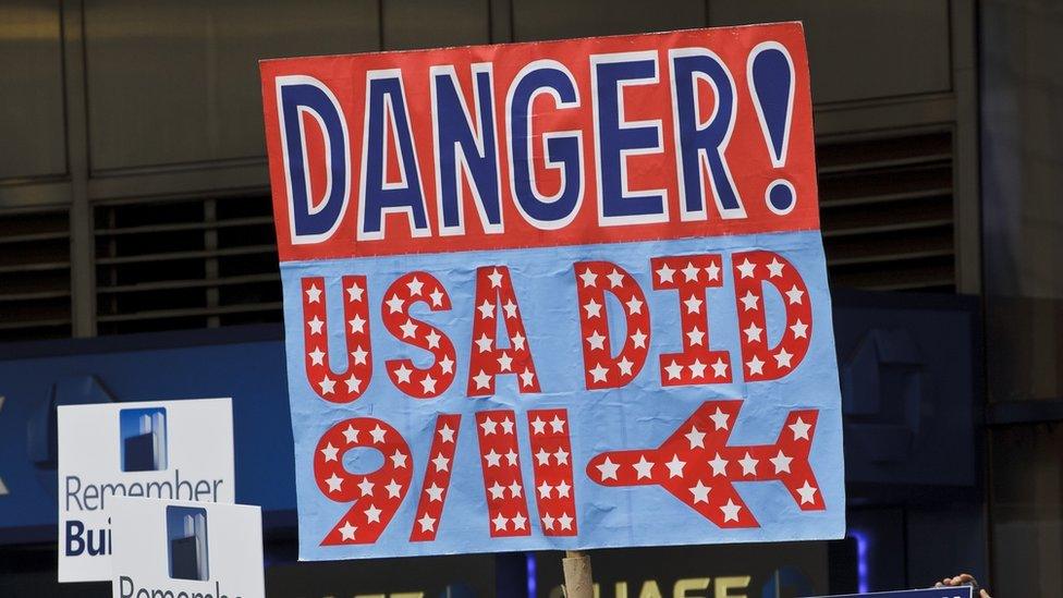 9/11 conspiracy theorists protest outside the memorial service at the World Trade Center construction site marking the 10th anniversary of the attacks on September 11, 2001.