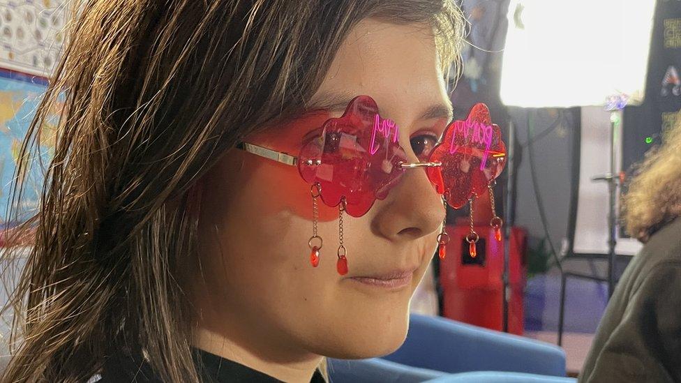 Teenager wearing pink cloud glasses