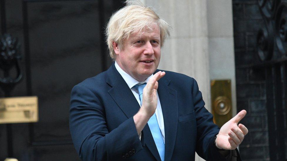 Boris Johnson clapping outside Downing Street