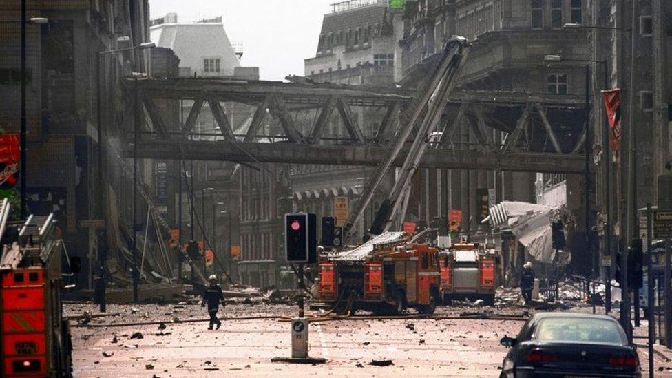 Firefighters at the scene of the IRA bomb blast at the Arndale Centre