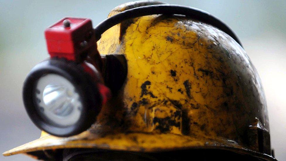 The helmet and lamp of a miner (archive shot)