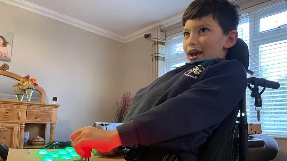 Corban playing on a specially-adapted console