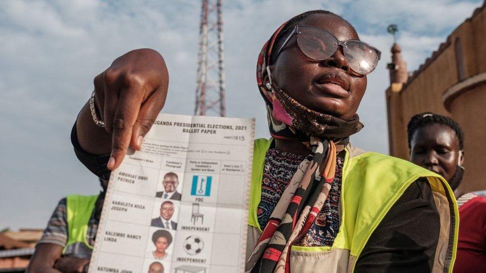 Woman holding up a ballot paper