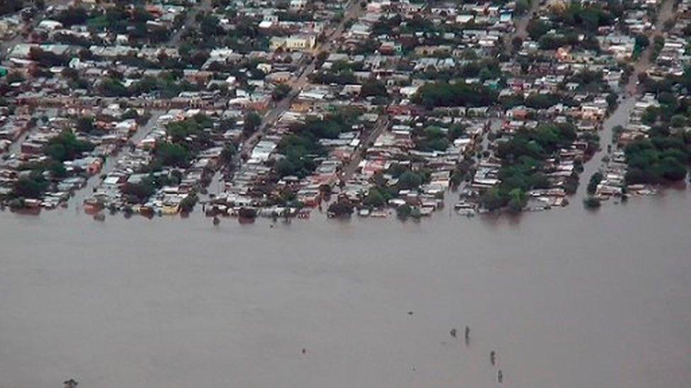 An aerial photograph shows flooding in Uruguay