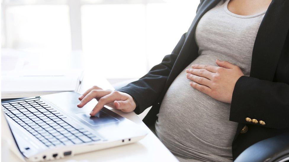 Pregnant woman on laptop