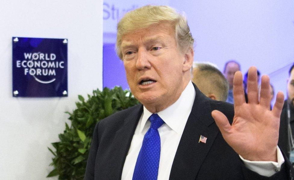 US President Donald Trump waves after a meeting at the World Economic Forum in Davos, Switzerland