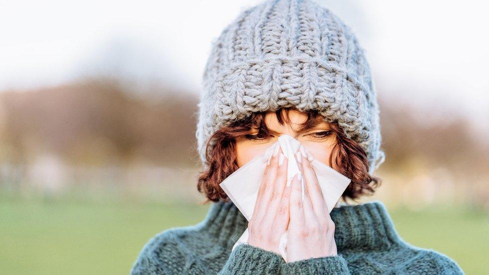 Woman blowing her nose