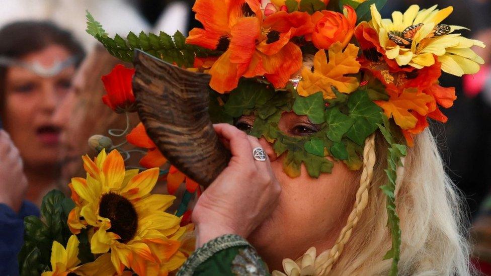 woman playing an instrument celebrating the summer solstice at Stonehenge