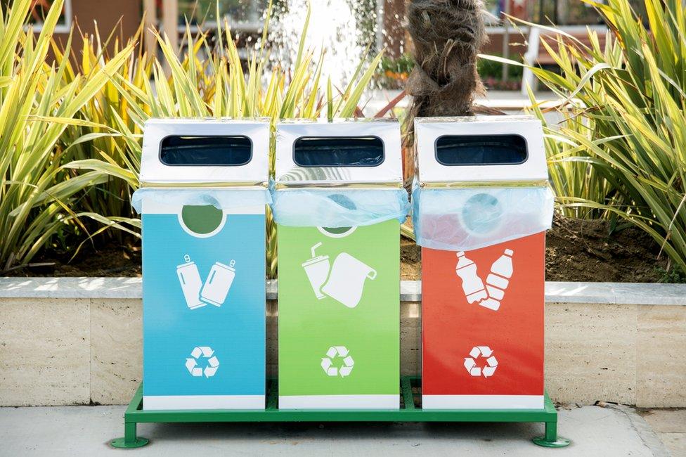 A line of recycling bins