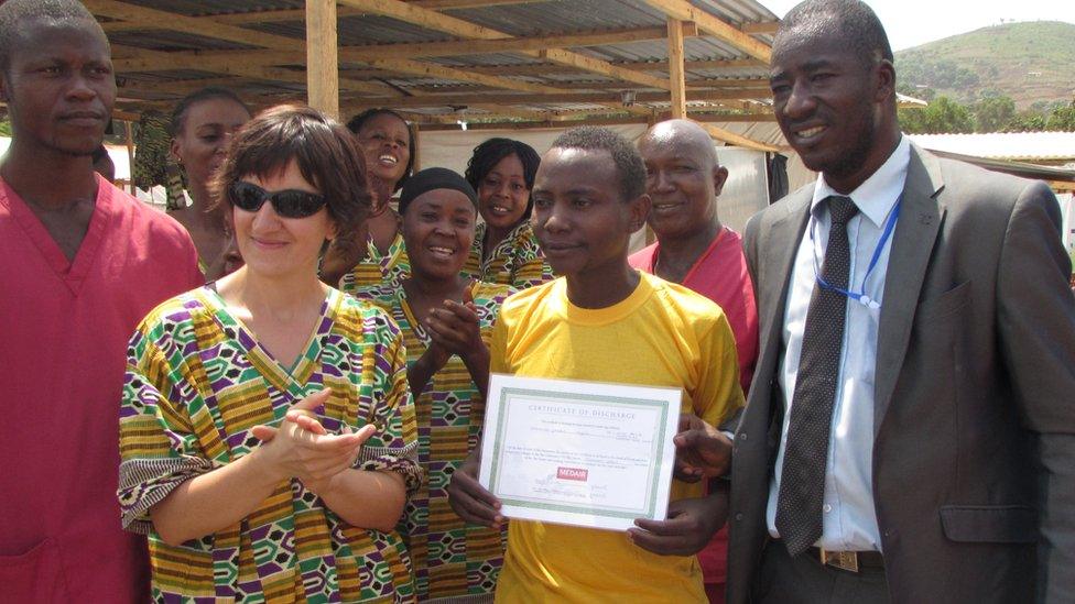 Prince Williams presenting a certificate