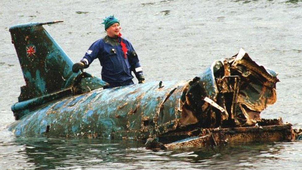 Bill Smith with the wreckage of Bluebird, which had been lifted from Coniston Water in 2001