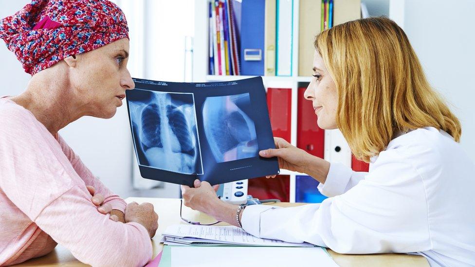 Doctor and woman with x-rays