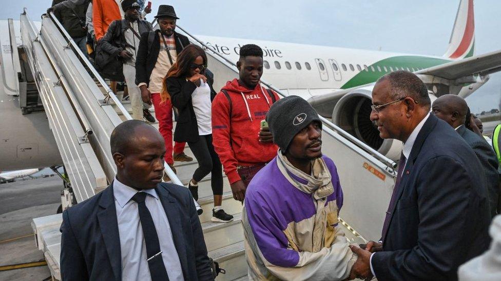 Ivorian Prime Minister Patrick Achi welcoming migrants repatriated from Tunisia