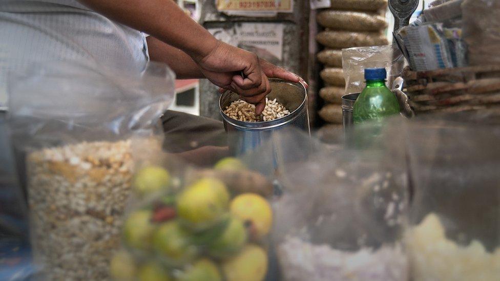 a vendor makes jhal muri