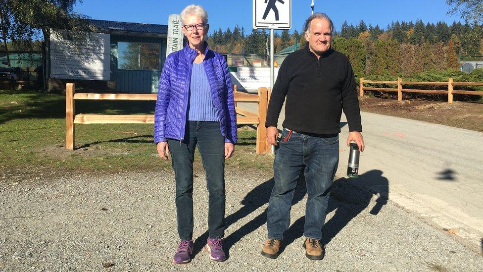 Susan Lambert and Jim Leyden stand near the Trans Mountain gates