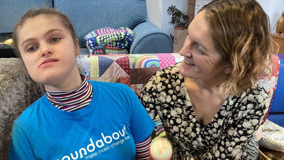 Mum Emily smiling towards her daughter, Lydia, as they enjoy a music session