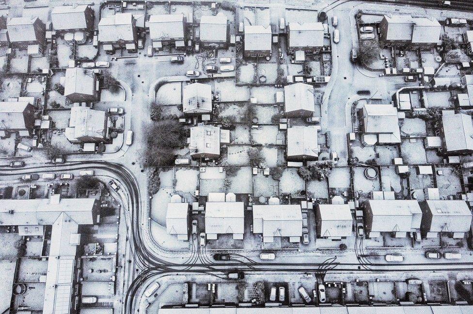 Aerial view of snow covered houses and streets