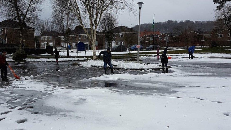 Parents help clear the school grounds at Creigiau, near Cardiff