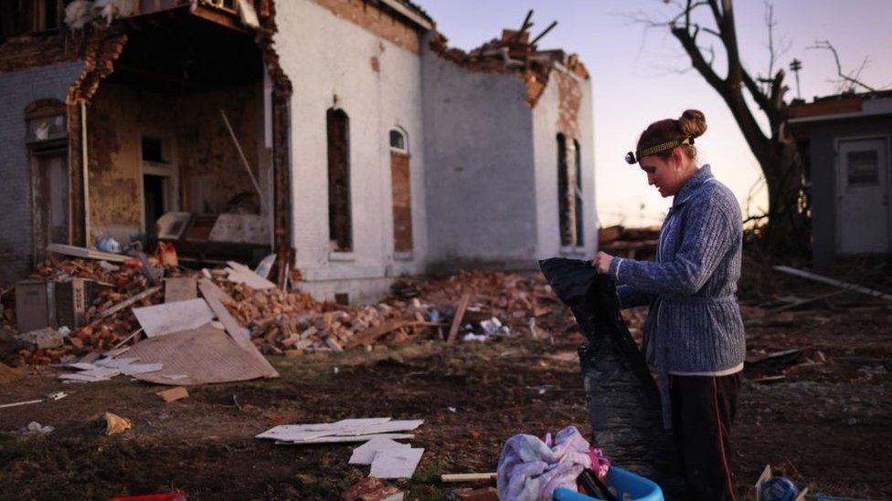 Resident salvages items from a home that was destroyed after a tornado ripped through the town of Mayfield