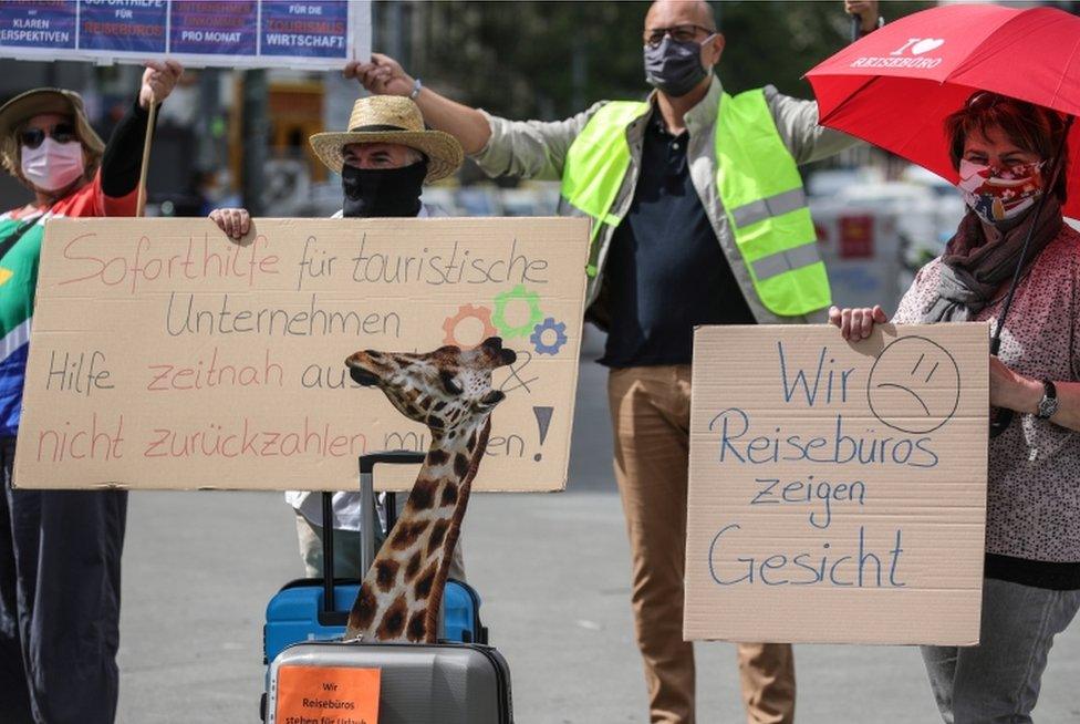 Employees of travel agencies, tour operators and bus companies, wearing face masks and keeping social distancing, demonstrate to demand support and rescue funding in Frankfurt am Main, Germany, 29 April 2020