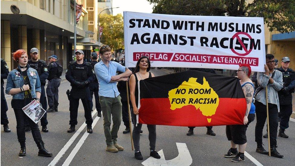 Anti-racism protesters are seen at a rally outside Parramatta Mosque after a Friday prayer, in Sydney on 09 October 2015