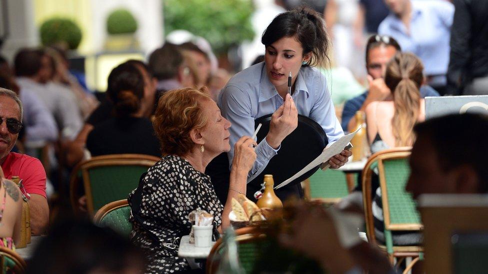 Waiter in outdoor restaurant