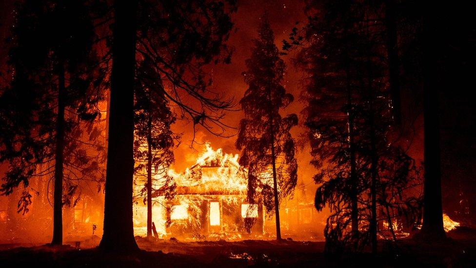 A home burns as flames from the Dixie fire tear through the Indian Falls neighbourhood of Plumas County, California on 24 July 2021.