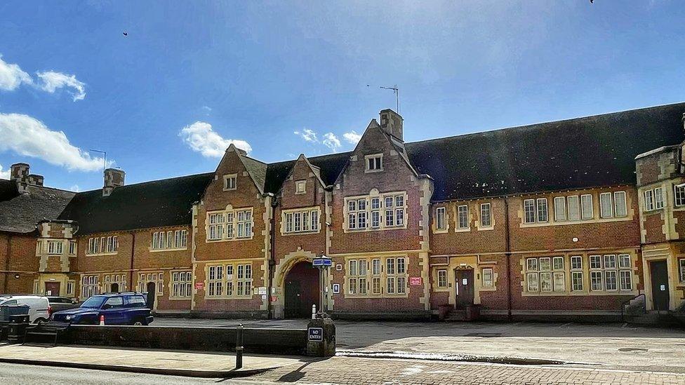 Front facade of 1930s brick building with archway