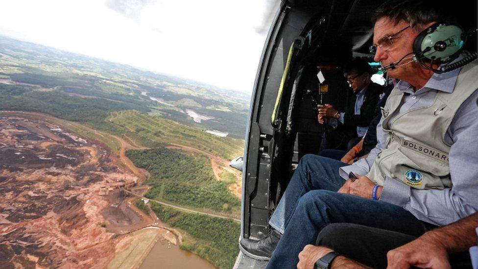 Brazilian President Jair Bolsonaro inside a helicopter flying over the area affected by the dam burst near Brumadinho, Minas Gerais, on 26 January 2019