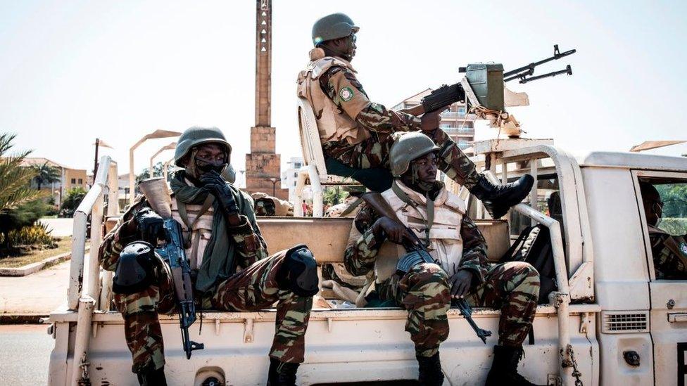 Soldiers from the Economic Community of West Africa States's (ECOWAS) security mission in Guinea-Bissau (ECOMIB) wait in their truck outside the presidential palace in Bissau on November 24, 2019