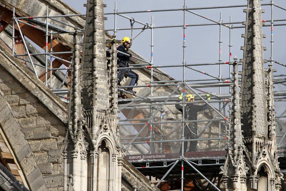 Workers are seen restoring the Notre-Dame cathedral