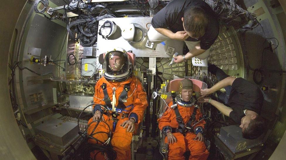 two Nasa mannequins on a nasa space ship