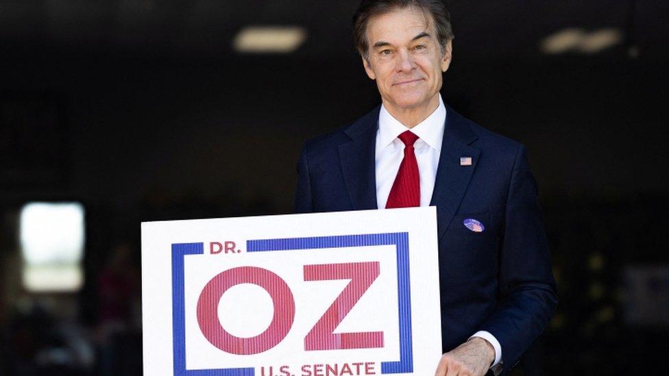 Mehmet Oz poses outside a polling location