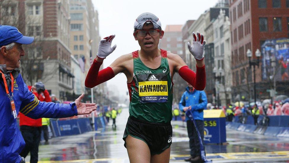 Yuki Kawauchi of Japan crosses the finish line to win the men's division