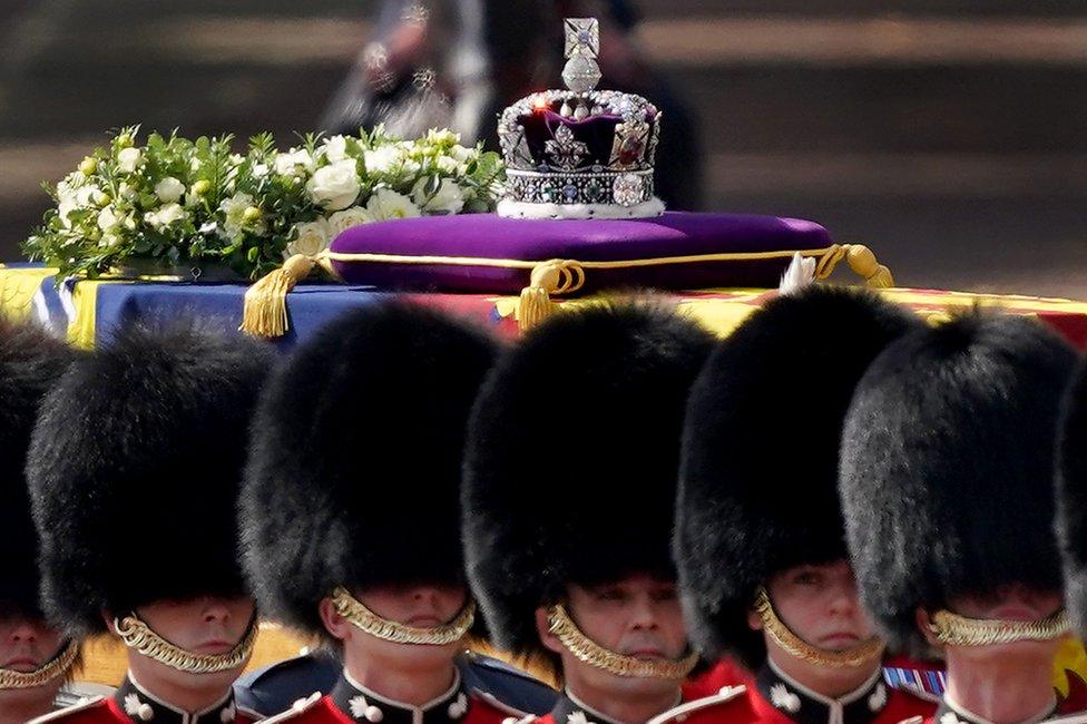 The coffin containing the body of Britain's Queen Elizabeth II, draped in the royal standard with the Imperial State Crown on top, is transported on a gun carriage of the King's Troop Royal Horse Artillery from Buckingham Palace to Westminster Hall followed by members of the royal family in London, Britain, 14 September 2022.