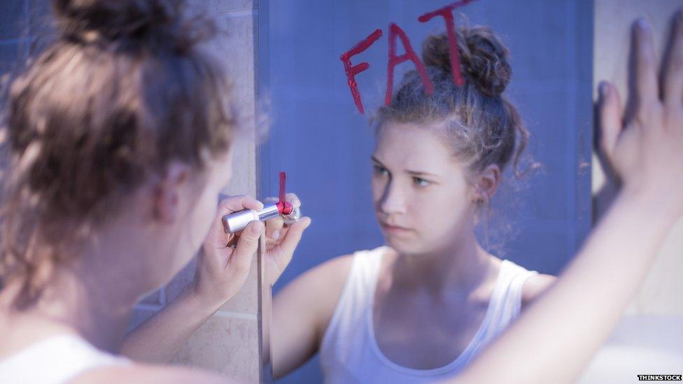 Girl writing on a mirror