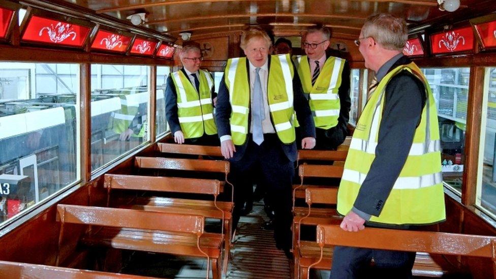 Boris Johnson and Secretary of State for Levelling Up, Housing and Communities Michael Gove view a vintage tram during their visit to the Blackpool Transport