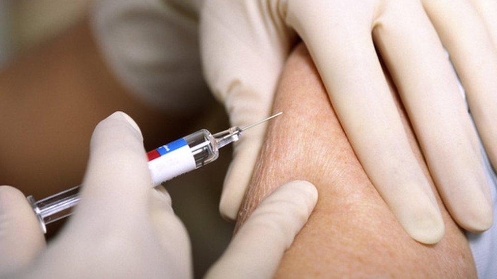 Flu vaccine being given to a patient