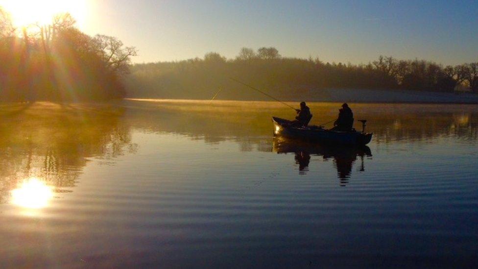 Men on a boat fly fishing