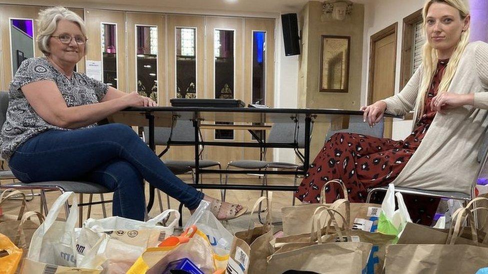 Volunteers pictured with food donations