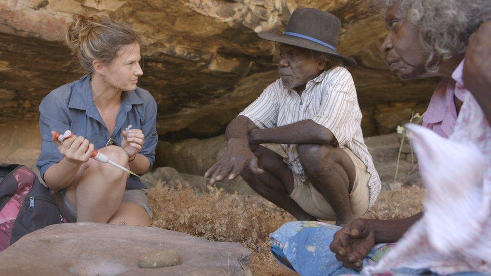 Scientists Dr Elspeth Hayes (left) with Mark Djandjomerr (centre) and May Nango (right) at the dig site