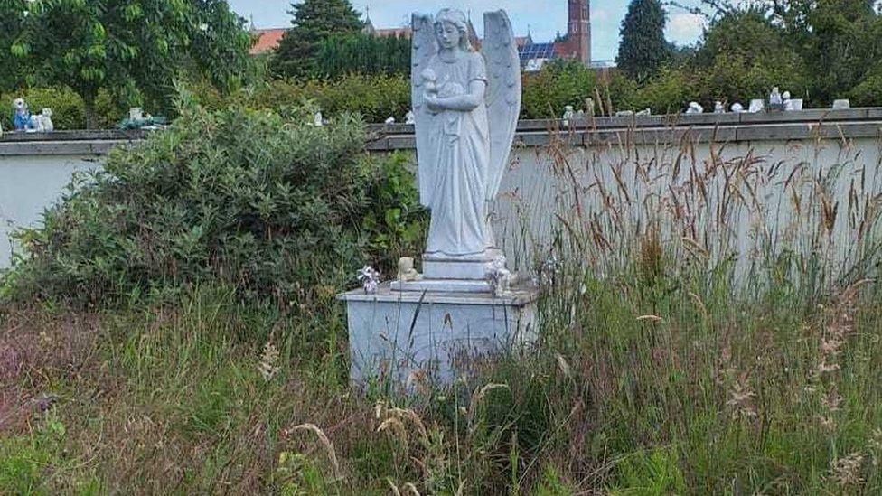 Overgrown memorial garden at Landican Cemetery