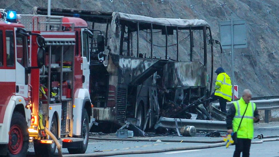 Officials work at the site of a bus accident, in which at least 45 people were killed after the vehicle caught fire, on a highway near the village of Bosnek, south of Sofia, on November 23, 2021