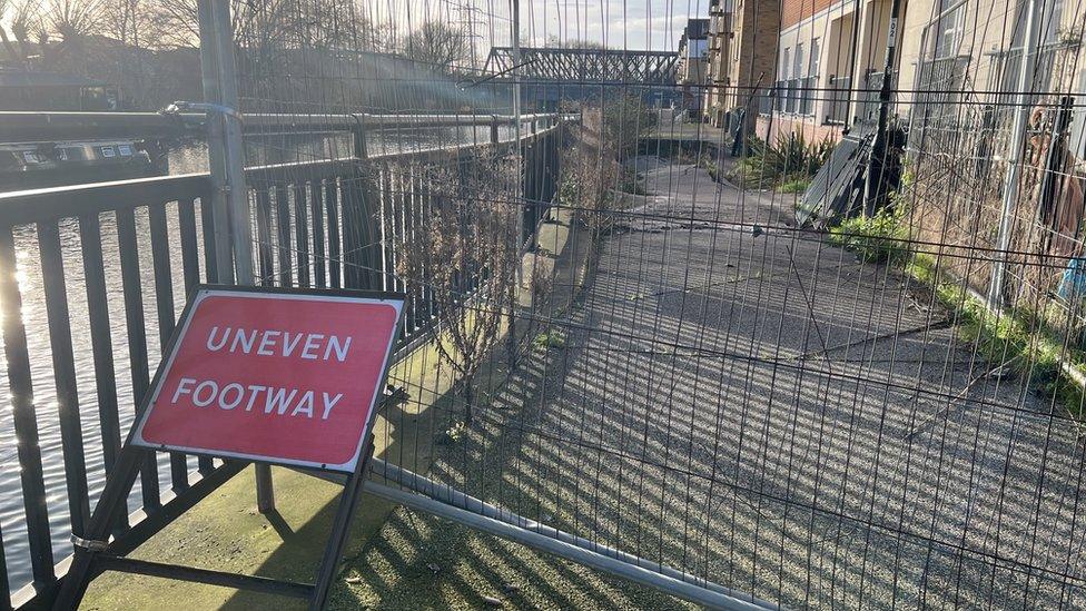 Sign and barrier blocking the footpath