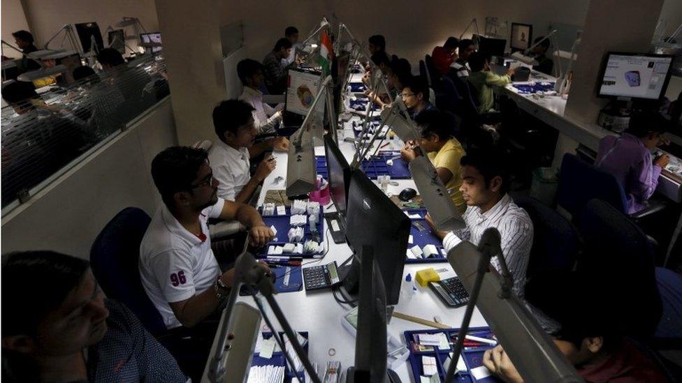Craftsmen work at the polishing department of a diamond processing unit at Surat in Gujarat, India, August 31, 2015