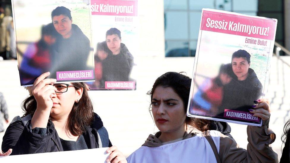 Women hold placards of Emine Bulut, who was killed by her husband, as they gather outside court in Kirikkale for the first hearing, 9 October 2019